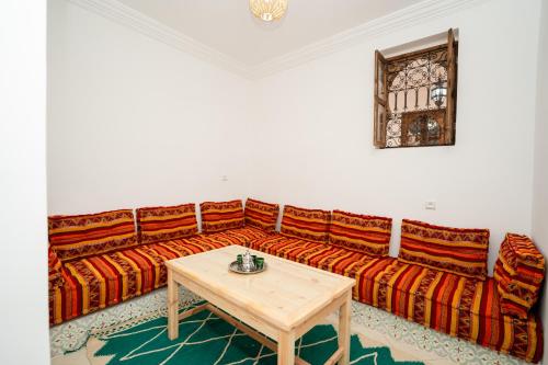a living room with a couch and a table at Dasofinya lodges in Touggana