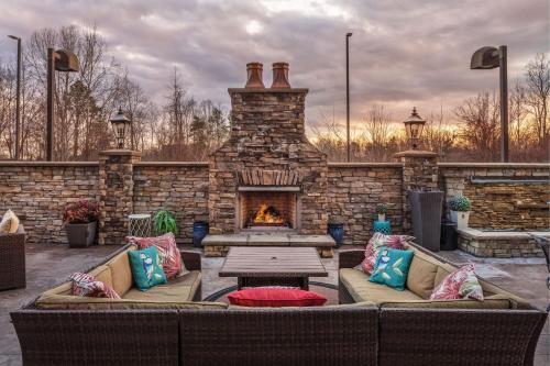 a patio with two couches and a fireplace at Fairfield Inn Suites Elkin Jonesville in Elkin