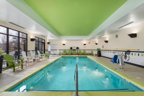 a large swimming pool in a hotel with chairs at Fairfield Inn Suites Elkin Jonesville in Elkin