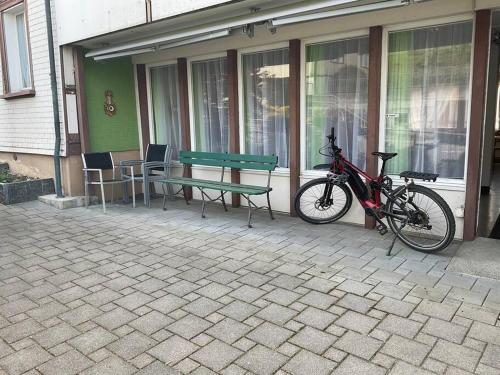 a bike parked next to a bench and a table at 01 - Gästehaus Erika - Hundwil - Appenzellerland in Hundwil