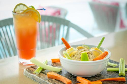 a bowl of vegetables and a drink on a table at Courtyard by Marriott Nassau Downtown/Junkanoo Beach in Nassau