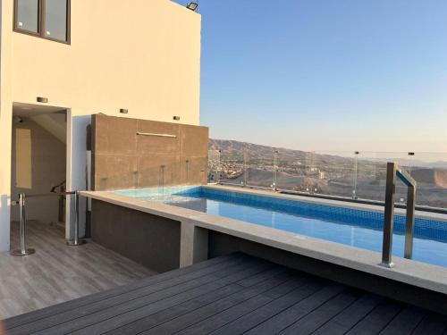 a swimming pool on the roof of a building at HOTEL PIEDRA SANTA - Moquegua in Moquegua