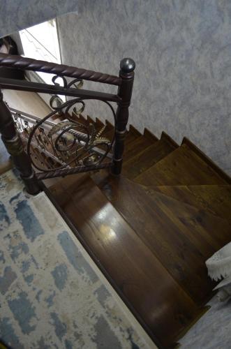 a wooden stairwell with a chair on top of it at Zara in Bishkek