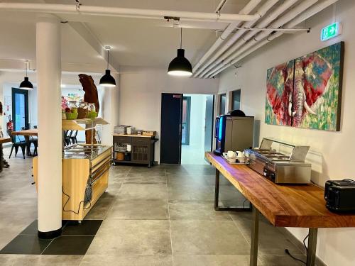 a kitchen with a counter and a table in a room at Les Cimes du Mont Royal in Montréjeau