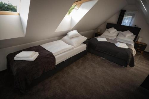 a bedroom with two beds with towels on them at Bobrowe Wzgórza Resort in Jelenia Góra