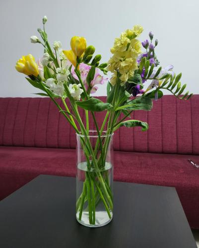a vase filled with flowers sitting on a table at Adac Boutique Hotel in Bucharest