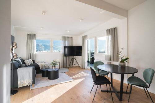 a living room with a couch and a table at LUXE VISTA City Apartments Algund in Lagundo