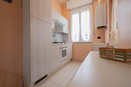 a kitchen with a white refrigerator and a window at dalla Linda - a due passi da Fiera Rho e Clinica San Carlo in Paderno Dugnano