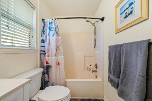 a bathroom with a toilet and a shower at Amazing Oceanfront 2BR Home Cozy Peaceful and Kid and Pet Friendly in Freeport