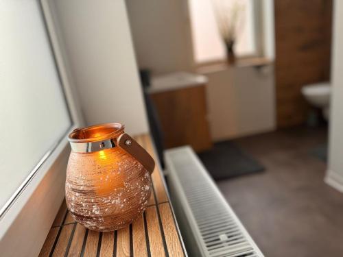 a vase sitting on a table in a room at Ferienwohnung Peggy in Eisenach