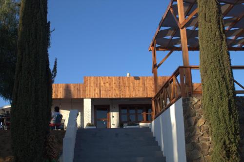 a house with a staircase leading up to it at Casa Ciprés in Valle de Guadalupe