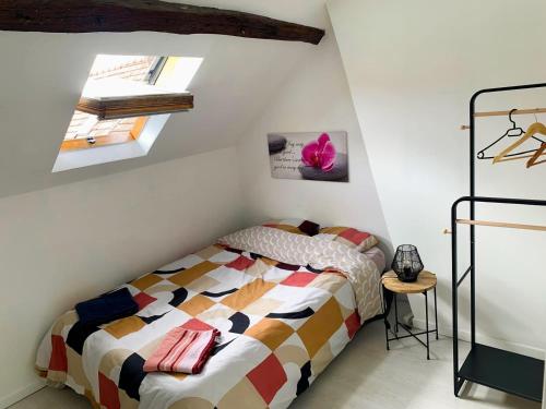 a bedroom with a bed and two skylights at La perle rare Chambly, Proche Parc Astérix , château de Chantilly in Chambly