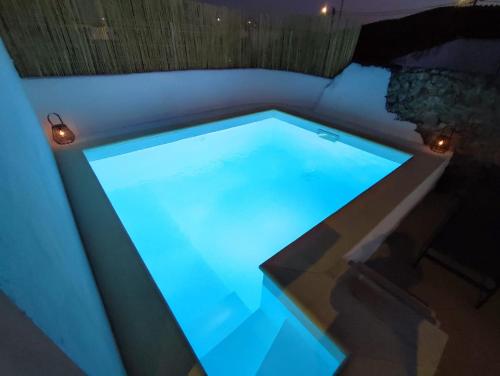 a swimming pool with blue lights on top of it at Casa da Pedra in Pedrógão