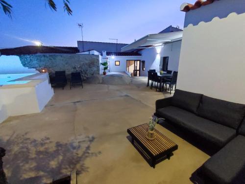 a living room with a couch and a table at Casa da Pedra in Pedrógão