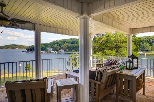 a porch with chairs and tables and a view of the water at Lake of the Ozarks Haven with Decks, Dock and Kayaks! in Roach
