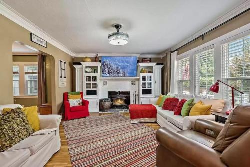 a living room with couches and a fireplace at 1930s Queen Anne Historic Downtown Retreat in Medford