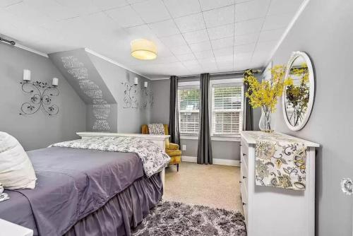 a bedroom with a bed and a table and a mirror at 1930s Queen Anne Historic Downtown Retreat in Medford