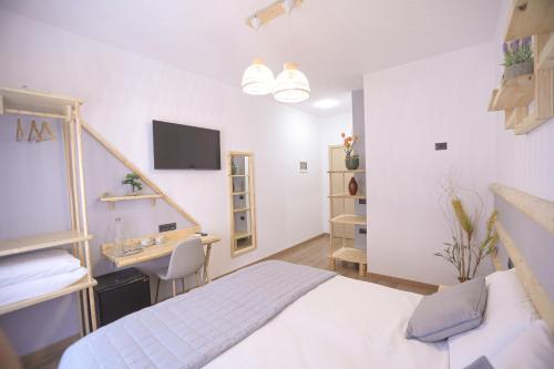 a bedroom with a bed and a desk and a sink at Nidum Harmony in Tirana
