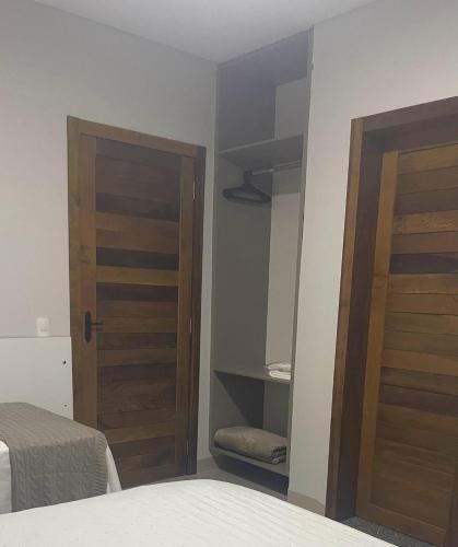 a bedroom with a closet with a door and a bed at Apart Hotel Neri in Sinop