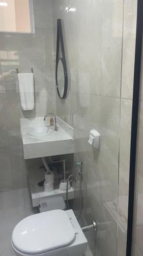 a bathroom with a toilet and a sink and a shower at Apart Hotel Neri in Sinop