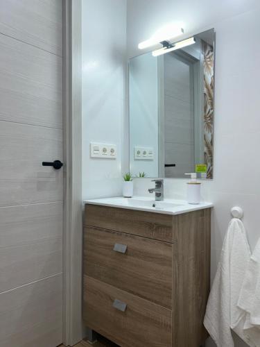 a bathroom with a sink and a mirror at La Casita de Josefa in Zahara de la Sierra