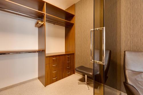 a room with a chair and a closet at Apartmán Leonardo - city center in Trnava
