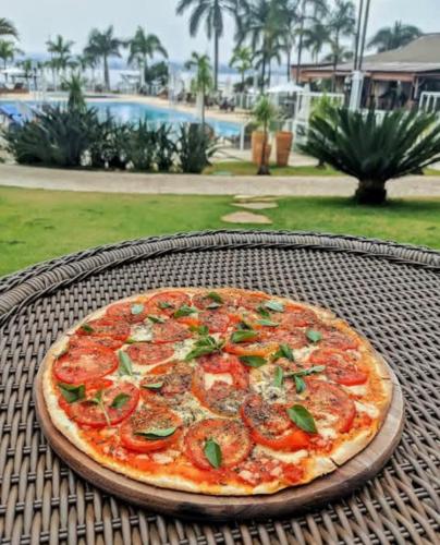 a pizza sitting on top of a table at Apartamento Life Resort Brasília in Brasilia