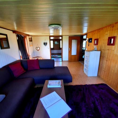 a living room with a couch and a table at appartement de campagne seul in Ursy