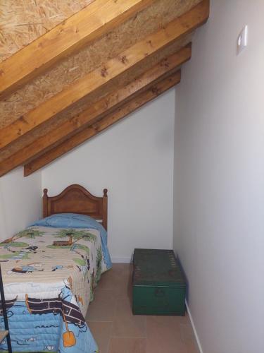 a bedroom with a bed and a wooden ceiling at Vó Laide in Carvalhal da Loiça
