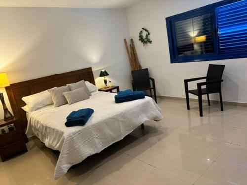 a bedroom with a bed with two blue towels on it at Villa Maiteren Etxea- 4 Beds property with private pool in Playa Blanca