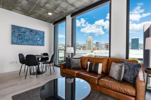 a living room with a couch and a table at Best views! Lux 9th fl Gym Pking Pool Htub King BD in Salt Lake City