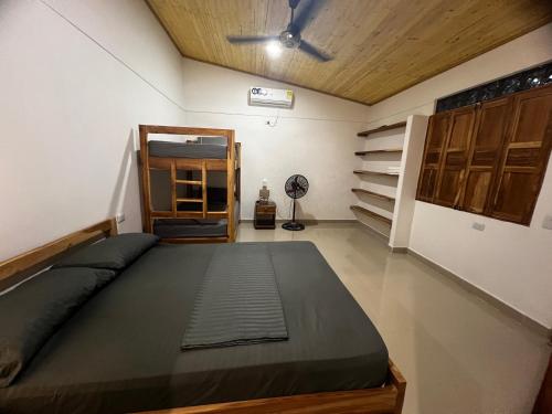 a bedroom with a bed and a ceiling fan at Cabaña OtraParte in Rincón