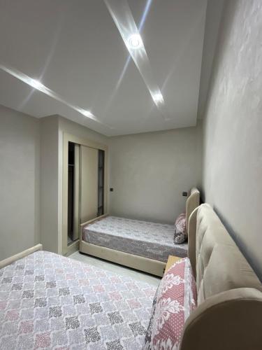 a bedroom with a bed and a couch at Mini Villa 2 Al hoceima in Al Hoceïma