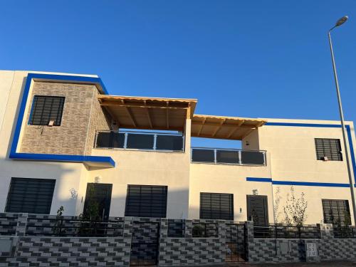 a building with a blue sky in the background at Mini Villa 2 Al hoceima in Al Hoceïma
