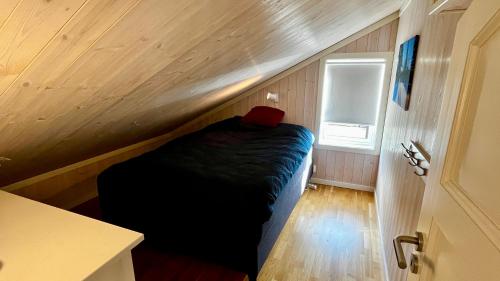 a small room with a bed in a tiny house at Modern cabin, great view, sunny, 2BA, 4BR in Hemsedal