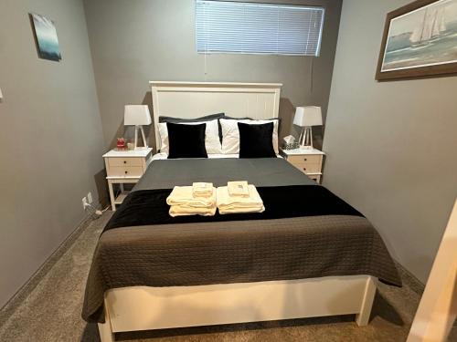 a bedroom with a bed with two towels on it at Stay549 in Winnipeg
