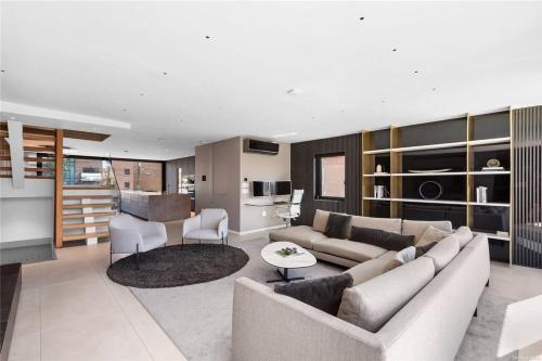 a living room with a couch and a table at 2 Story Villa in Upper Ditmars Astoria Queens in Steinway