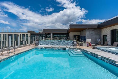 a swimming pool on top of a building at Best views! Lux 9th fl Gym Pking Pool Htub King BD in Salt Lake City