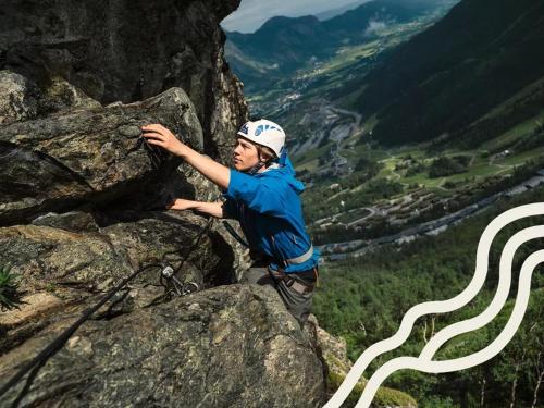 a man standing on the side of a mountain at Modern cabin, great view, sunny, 2BA, 4BR in Hemsedal