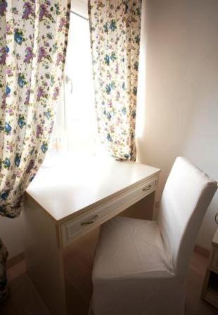 a white desk with a chair in front of a window at La Finestra Su Roma in Frascati