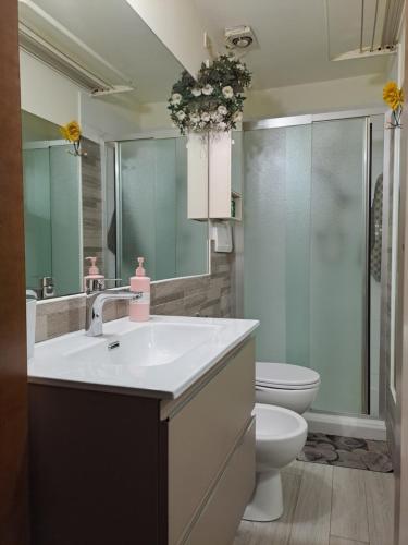 a bathroom with a white sink and a toilet at OASI San Lorenzo in Genova