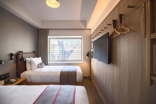 Postel nebo postele na pokoji v ubytování MOXY Tokyo Kinshicho