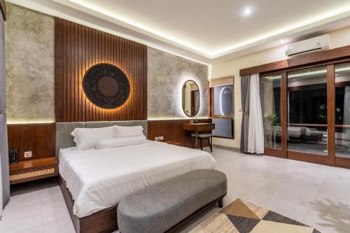 ヌサドゥアにあるTaman Dharmawangsa Villa - 3BR Luxury Private Pool Villa in Nusa Duaの大きな白いベッドと机のある寝室