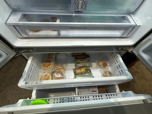 an open refrigerator with food inside of it at Stay549 in Winnipeg