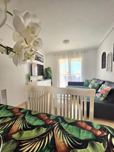a living room with a couch and a white chair at Apartament Carina in Mar de Cristal