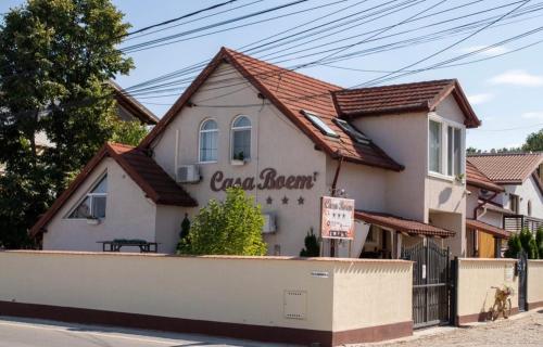 a building with a sign for a restaurant at Casa Boem in Mogoşoaia