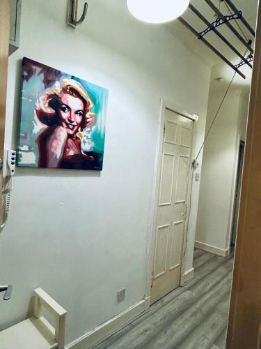 a painting of a woman on a wall at 2B apartment near Glasgow SEC, OVO Hydro & city centre in Glasgow