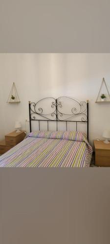 a bedroom with a bed and two night stands at Lo Conseguí in Bollullos de la Mitación