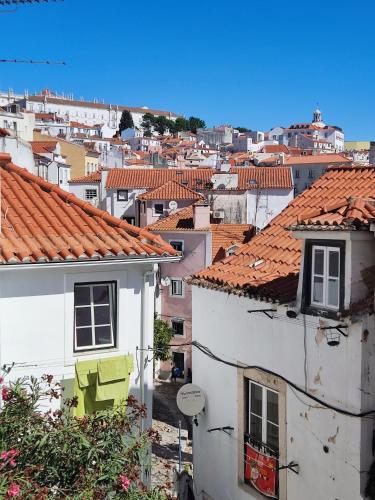 a view of a city with buildings and roofs at Cozy flat with marvelous view in Lisbon