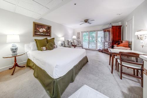 a bedroom with a large white bed and a desk at Experience Chautauqua! Newly Renovated Studio in Chautauqua